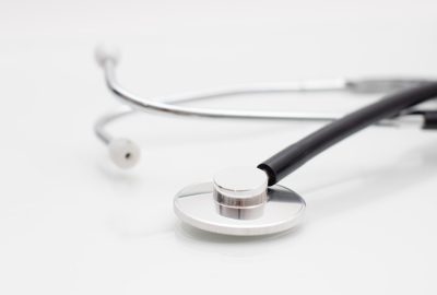 Medical stethoscope on white background. Close-up of phonendoscope. Doctor's tool. Selective focus.
